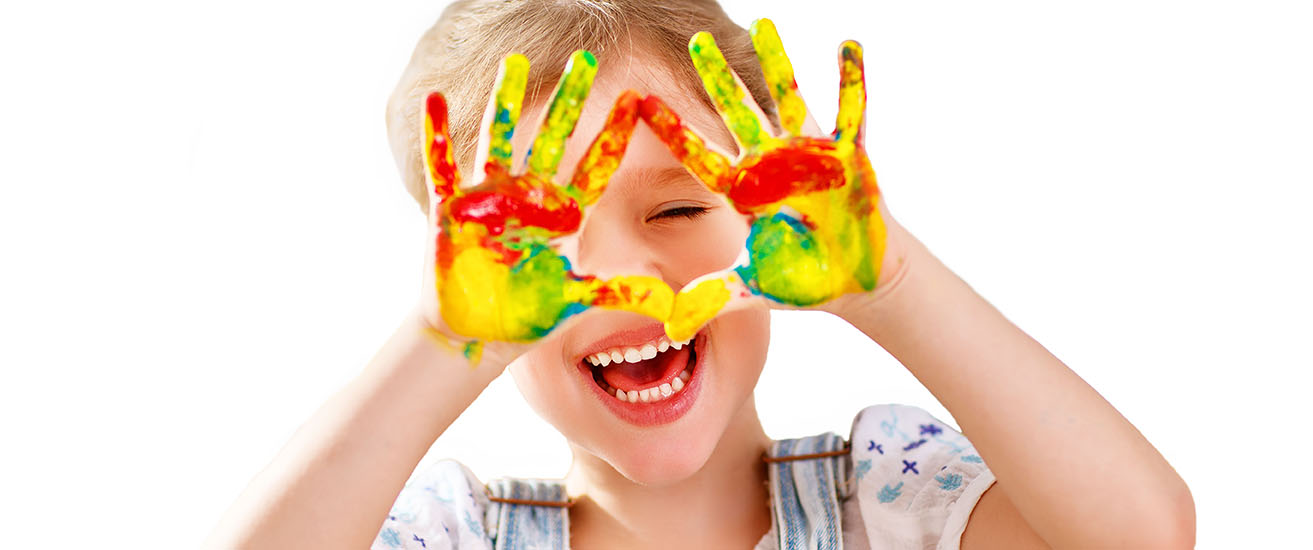 Girl having fun with colorful painted hands